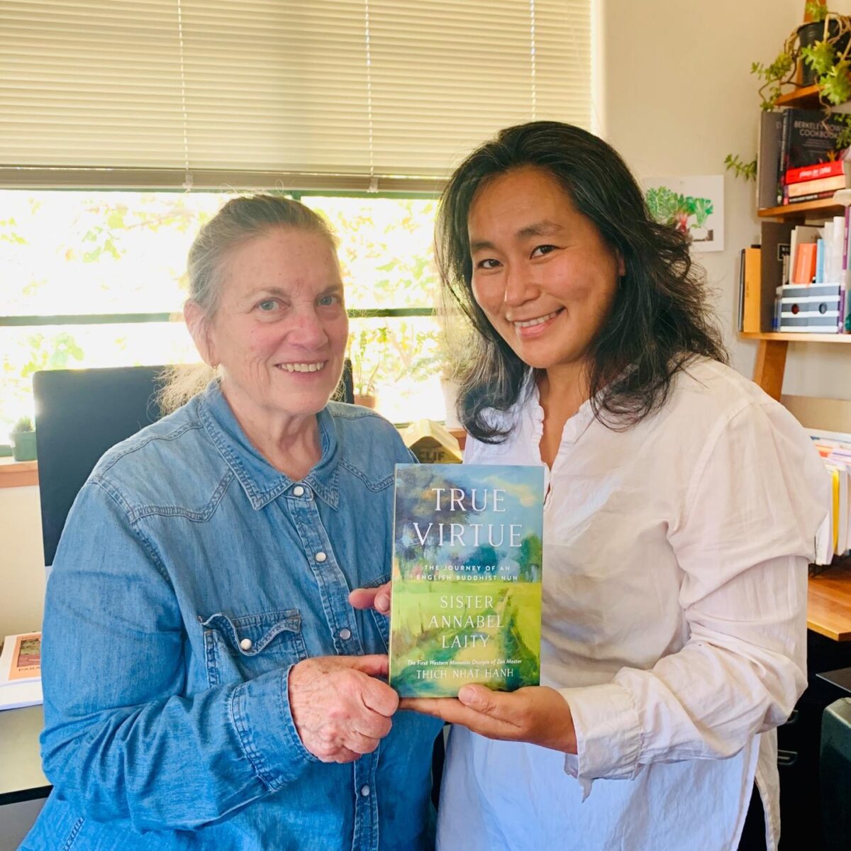 Terry Barber and Hisae Matsuda, smiling and holding a copy of book True Virtue